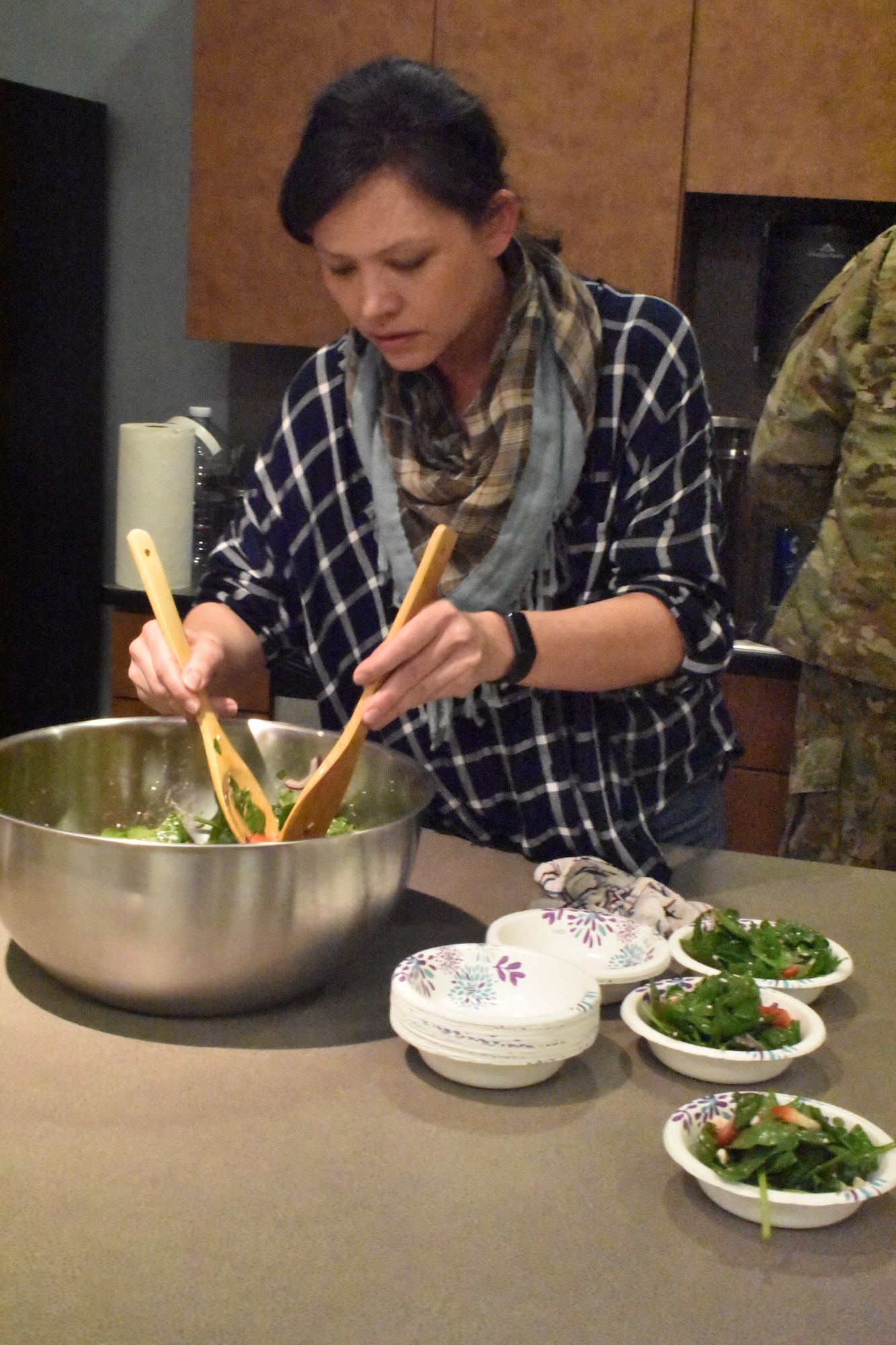 Yi Lynne Weber, Harvest Ridge Winery chef, tosses a salad Feb. 13, 2019, at Dover Air Force Base, Del. Weber participated as a guest chef for Dorm to Gourm: a base continuing education program that partners with local chefs to develop and equip Airmen with cooking skills to take care of themselves and their families. (U.S. Air Force photo by 2nd Lt. Lorraine Cho)