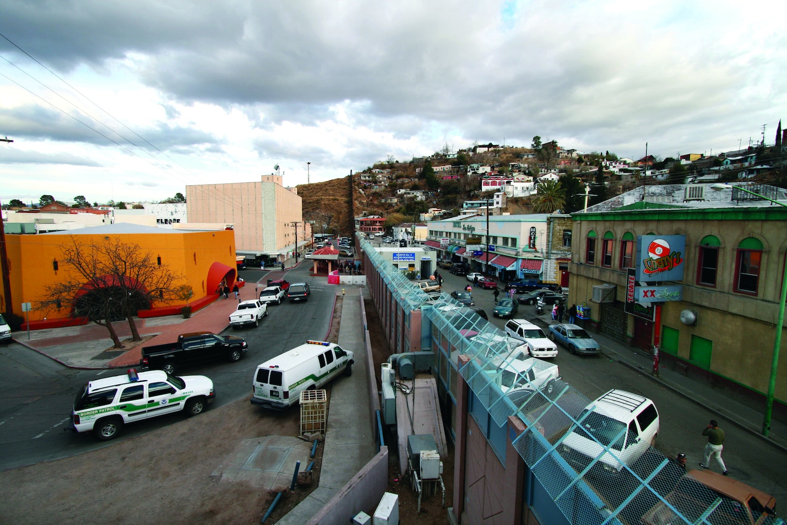 The towns of Nogales, Ariz., left, and Nogales, Mexico, stand separated by a high concrete and steel fence, Thursday, Jan. 18, 2007. Many consider the area one of the most dangerous along the border with numerous reports from U.S. Border Patrol agents of being spit on, having rocks thrown at them, and gunfire. Despite the existence of a legal crossing point, enough illegal crossings occur to warrant 24-hour Border Patrol operations there. (U.S. Army photo by Sgt. 1st Class Gordon Hyde) (Released)