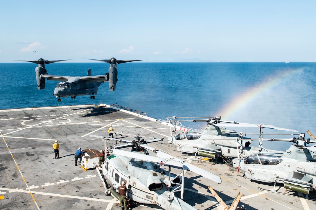 A helicopter lands on a ship.