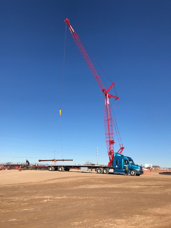 Steel girders are unloaded by crane at the NNSA Albuquerque Complex site, Dec. 19, 2018.