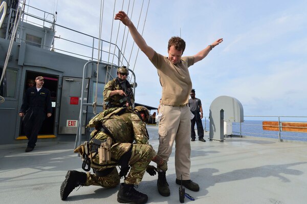GULF OF THAILAND (Feb. 18, 2019) - Royal Marine commandos attached to the Duke-class frigate HMS Montrose (F 236) search Civilian Mariner Chief Mate Eric Naranjo, during a visit, board, search and seizure (VBSS) drill aboard the Henry J. Kaiser-class fleet replenishment oiler USNS Guadalupe (T-AO 200).