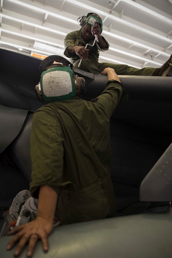 U.S. Marines assigned to the 22nd Marine Expeditionary Unit, install a panel on the wing of an AV-8B Harrier in the hanger bay of the Wasp-class amphibious assault ship USS Kearsarge. Marines attached to Marine Medium Tiltrotor Squadron 264 perform routine maintenance on Harriers located aboard the Kearsarge to ensure that they will remain operationally functional while at sea. Marines and Sailors with the 22nd MEU and Kearsarge Amphibious Ready Group are deployed to the 5th Fleet area of operations in support of naval operations to ensure maritime stability and security in the Central Region, connecting the Mediterranean and the Pacific through the western Indian Ocean and three strategic choke points. (U.S. Marine Corps photo by Lance Cpl. Tawanya Norwood)