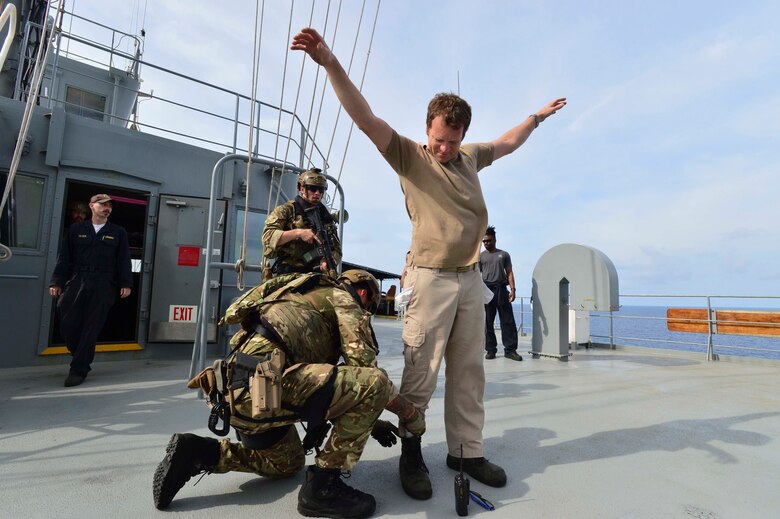 GULF OF THAILAND (Feb. 18, 2019) - Royal Marine commandos attached to the Duke-class frigate HMS Montrose (F 236) search Civilian Mariner Chief Mate Eric Naranjo, during a visit, board, search and seizure (VBSS) drill aboard the Henry J. Kaiser-class fleet replenishment oiler USNS Guadalupe (T-AO 200).