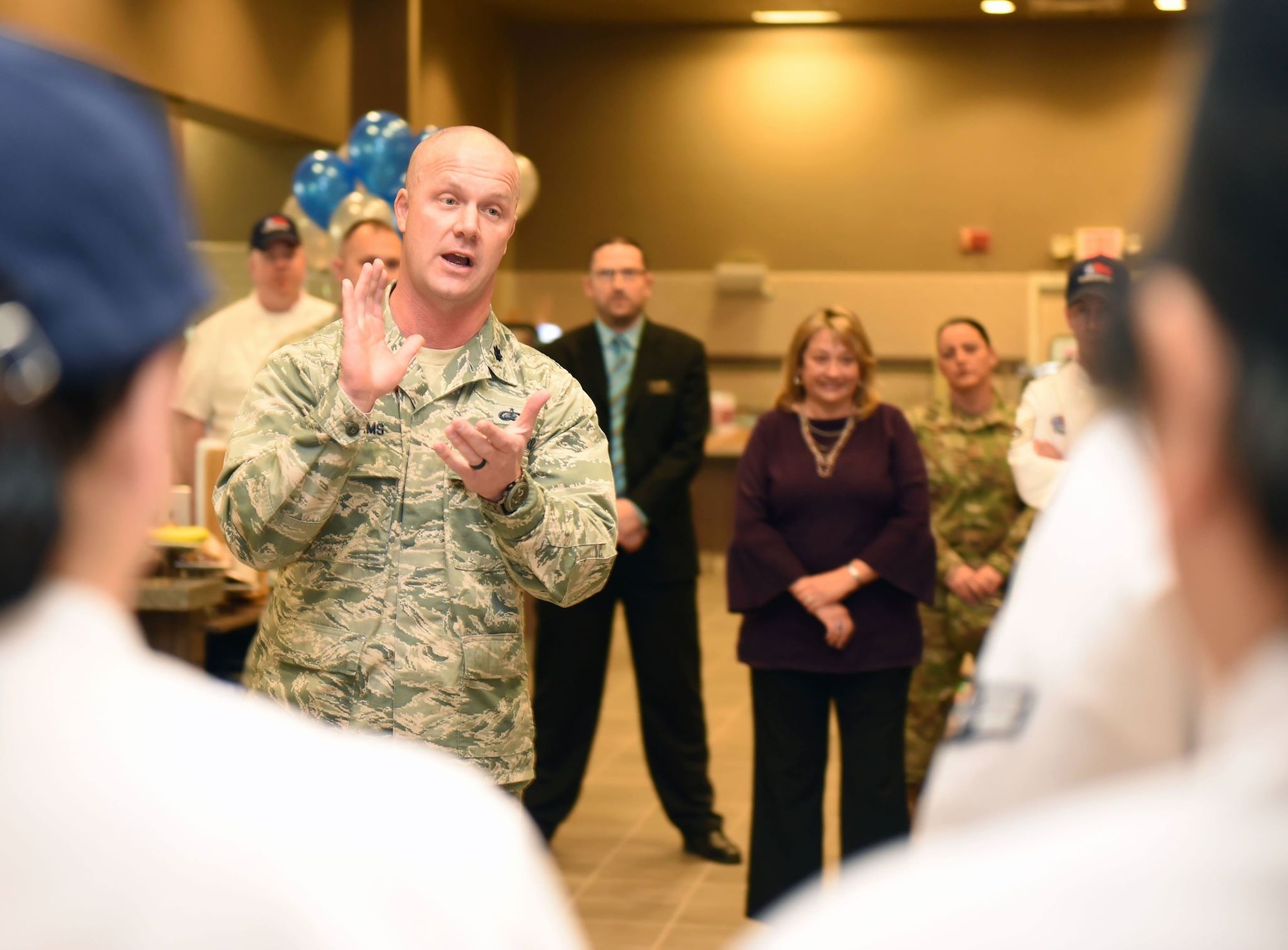 Lt. Col. Nathan Williams, 60th Force Support Squadron commander, addresses Airmen ahead of the grand re-opening of Travis Air Force Base's dining facility, renamed the Monarch. Williams took time before allowing in the crowd to offer praise to 60th FSS Airmen whose work he lauded for its contribution to the facility's updates. (U.S. Air Force photo by Airman 1st Class Christian Conrad)