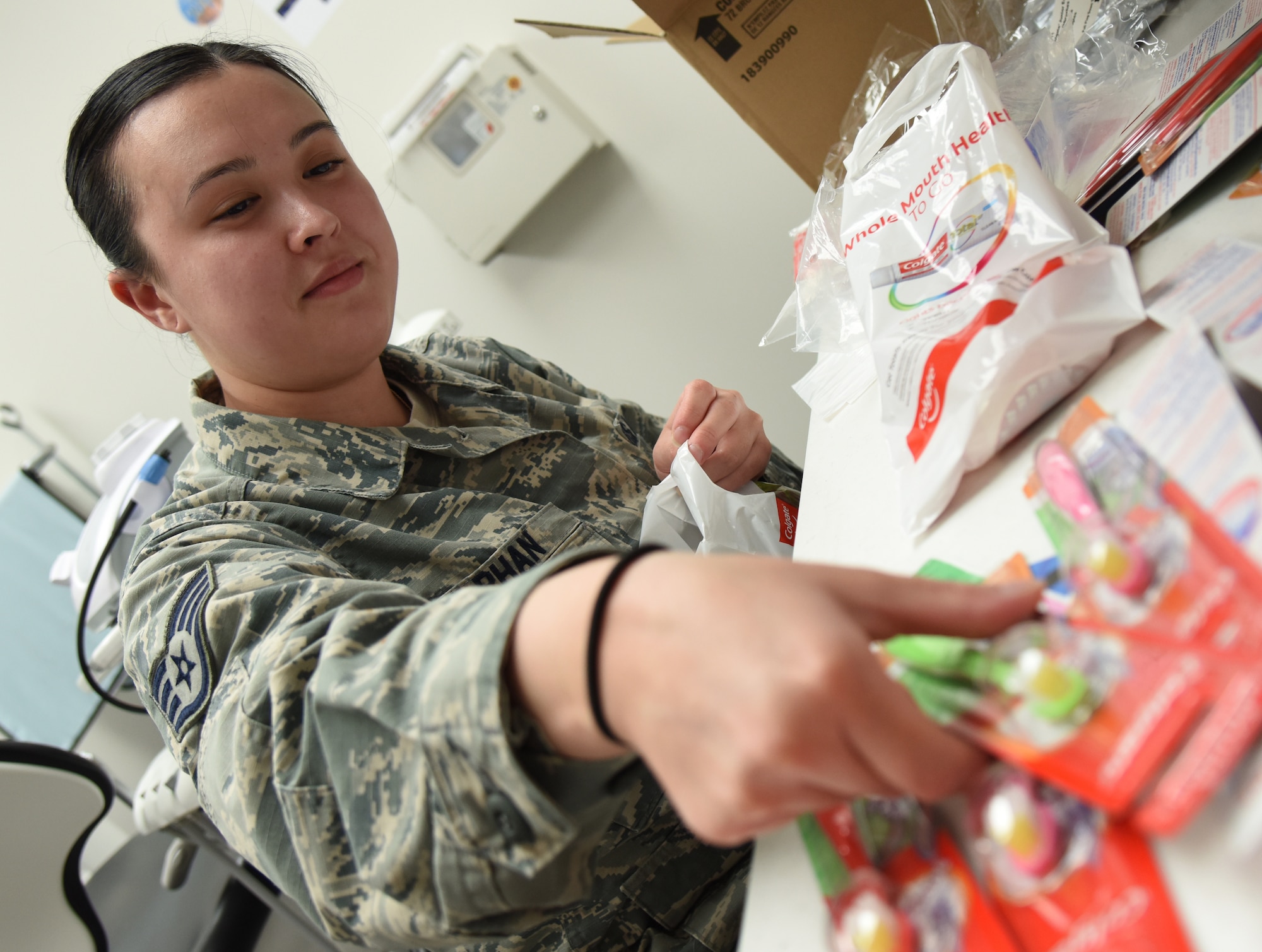 U.S. Air Force Staff Sgt. Iva Phan, 81st Dental Squadron dental assistant, places toothbrushes in bags for military children during the 9th Annual Give Kids a Smile Day at the dental clinic inside the Keesler Medical Center at Keesler Air Force Base, Mississippi, Feb. 15, 2019. The event was held in recognition of National Children's Dental Health Month and included free dental exams, radiographs and cleanings for children age two and older. (U.S. Air Force photo by Kemberly Groue)
