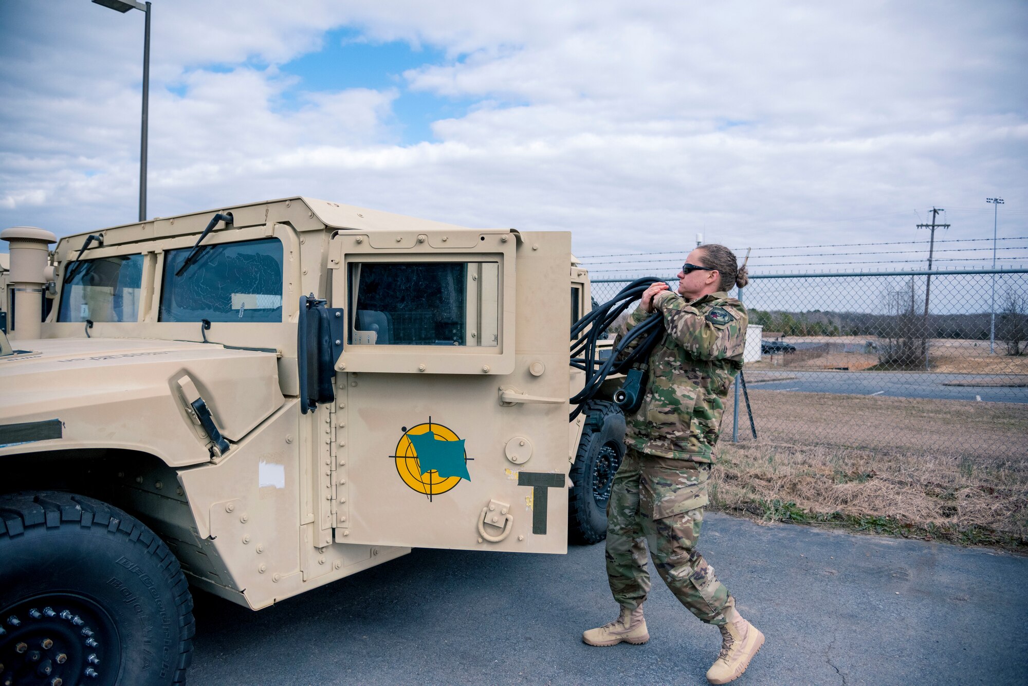 Master Sgt. Stacy Hunt, 34th Combat Training Squadron mission support operations superintendent and 913th Airlift Group traditional reservist, unloads jumper cables from a Humvee.