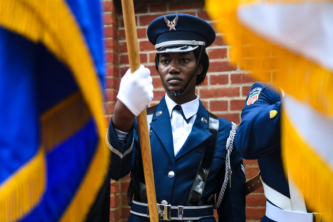 An airman holds a flag.