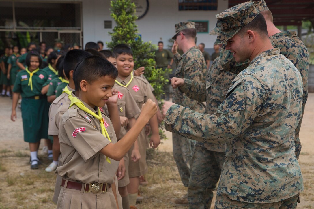 Marines greet a group of students.