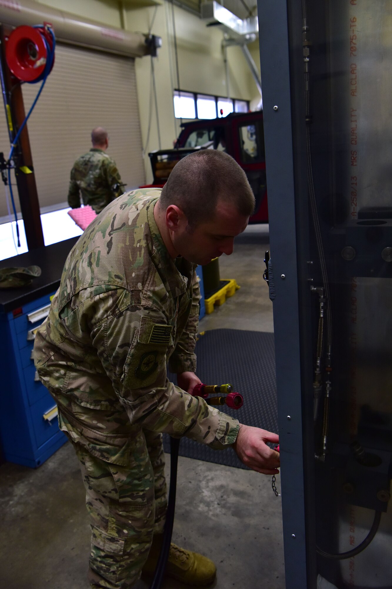 Airman connects hose to safety fixture.