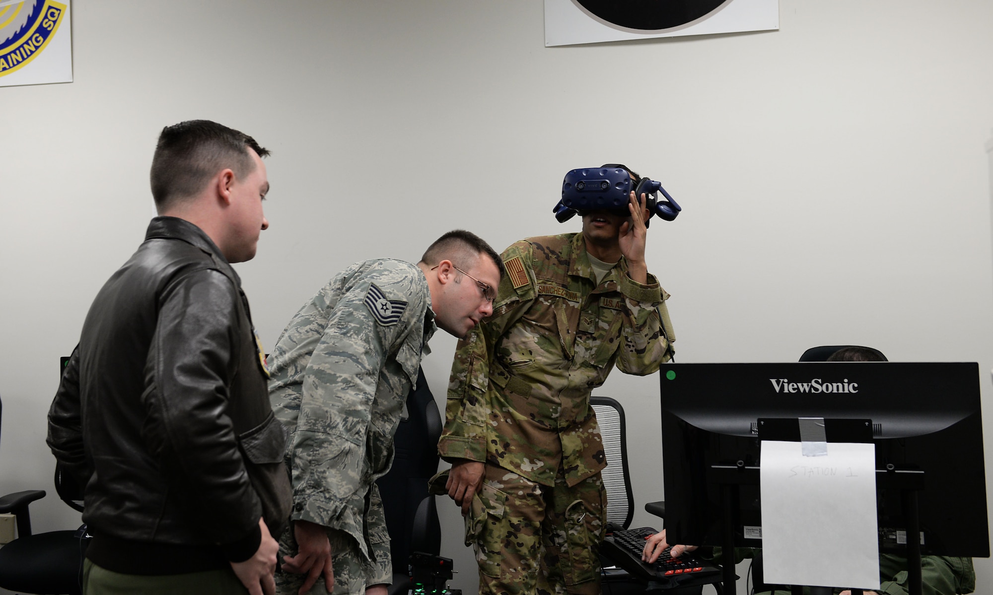 Airmen from the 552nd Air Control Wing at Tinker Air Force Base, Oklahoma, try on virtual reality equipment Feb. 13, 2018, on Columbus AFB, Mississippi. They toured areas in the 14th Operations Group to see how the Columbus AFB Spark Cell has aided in projects utilizing the innovation for faster and better daily operations. (U.S. Air Force photo by Airman Hannah Bean)