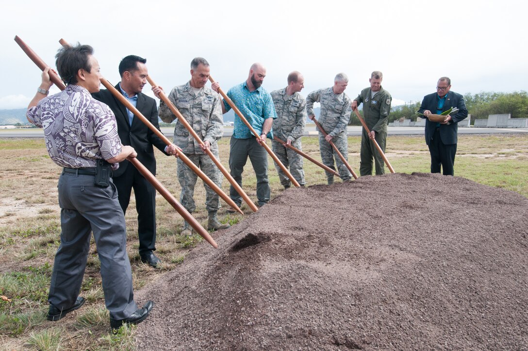 Representatives from Pacific Air Forces, 154th Wing, 15th Wing, Air Force Civil Engineer Center, and the United States Army Corps of Engineers participate in a ground-breaking ceremony for the new F-22 Aerospace Control Alert Facility.