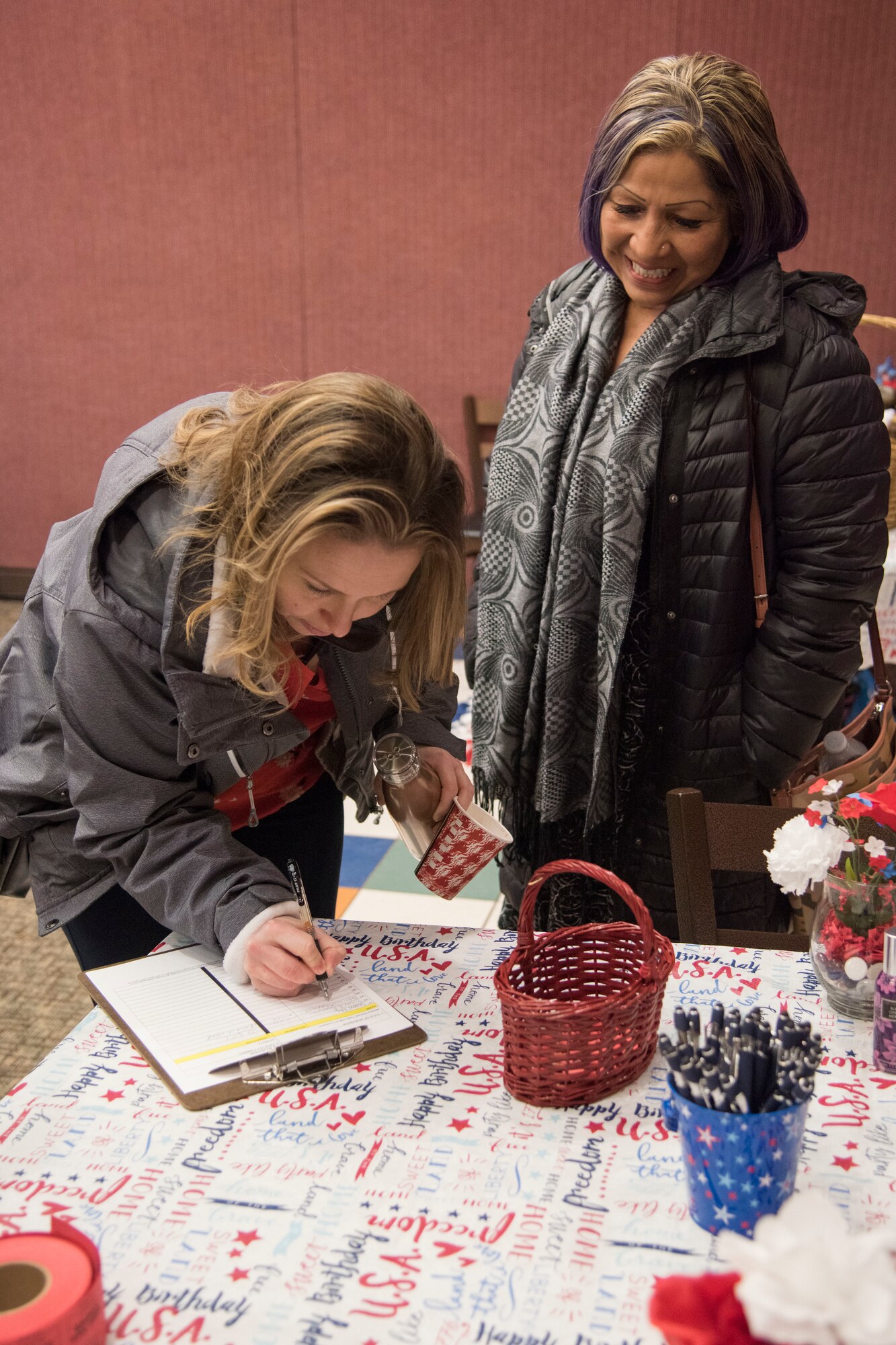 Attendees sign in during a military spouse town hall and luncheon at Joint Base Elmendorf-Richardson, Alaska, Feb. 12, 2019. The Military and Family Readiness Center-hosted event had more than 120 attendees with the theme “Taking Care of People.”