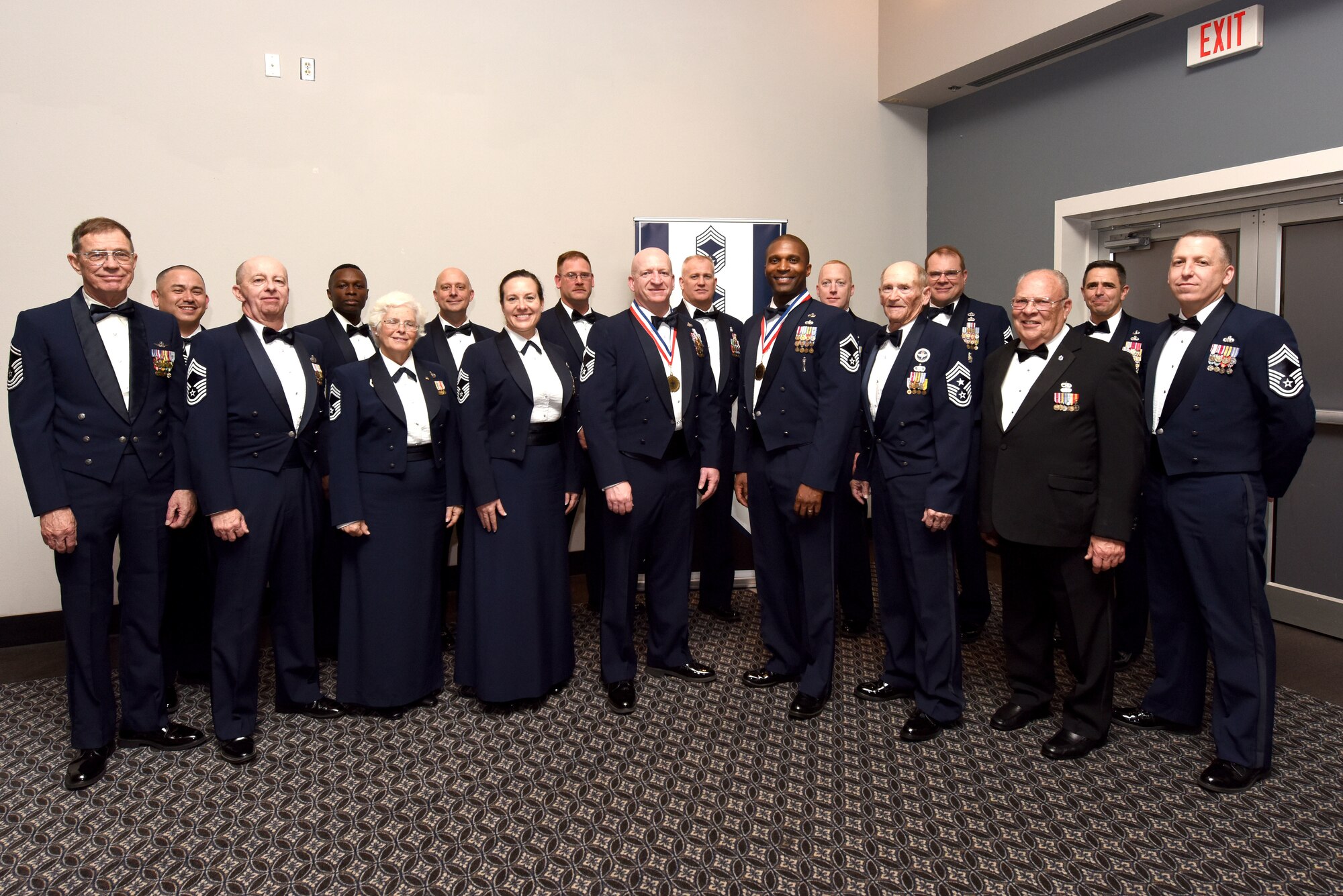 Current and retired U.S Air Force Chief Master Sergeants from Goodfellow, stand for a picture with the newest members to be inducted into the rank of Chief Master Sgt. after the Chief Induction Ceremony at the Event Center on Goodfellow Air Force Base, Texas, Feb. 15, 2019. Members of Goodfellow, friends and family gathered to congratulate Senior Master Sgt. Jeffrey Henson and Senior Master Sgt. Jerome Wright on earning their promotion. (U.S. Air Force photo by Senior Airman Seraiah Hines/Released)