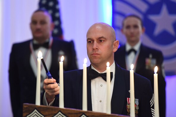 U.S. Air Force Chief Master Sgt. Shawn Andrews, 81st Security Forces Squadron manager, participates in a candle-lighting ceremony during the Chief Induction Ceremony inside the Bay Breeze Event Center at Keesler Air Force Base, Mississippi, Feb. 15, 2019. During the candle-lighting ceremony a candle is lit for each rank of the enlisted structure an Airmen wears on their way to the rank of chief master sergeant. Five Keesler Airmen earned their chief master sergeant stripe during the 2019 promotion release. Air Force officials selected 479 senior master sergeants for promotion to chief master sergeant out of 2,241 eligible for a selection rate of 21.37 percent. Chief master sergeants make up one percent of the Air Force enlisted force. (U.S. Air Force photo by Kemberly Groue)