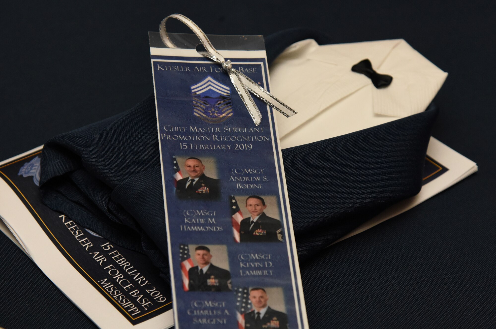 Event memento book marks and tuxedo napkins are displayed during the Chief Induction Ceremony inside the Bay Breeze Event Center at Keesler Air Force Base, Mississippi, Feb. 15, 2019. Five Keesler Airmen earned their chief master sergeant stripe during the 2019 promotion release. Air Force officials selected 479 senior master sergeants for promotion to chief master sergeant out of 2,241 eligible for a selection rate of 21.37 percent. Chief master sergeants make up one percent of the Air Force enlisted force. (U.S. Air Force photo by Kemberly Groue)