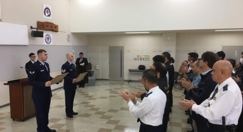Senior Airman Justin Kannenberg and Tech. Sgt. Argo Cesareo, both, aircraft recovery for the 18th Equipment Maintenance Squadron, were recognized by the Uruma Police Station in Uruma City, Japan, Jan. 28, 2019, for putting out a local fire. The Airmen saw the fire on their way to dinner and immediately took action until emergency services arrived.