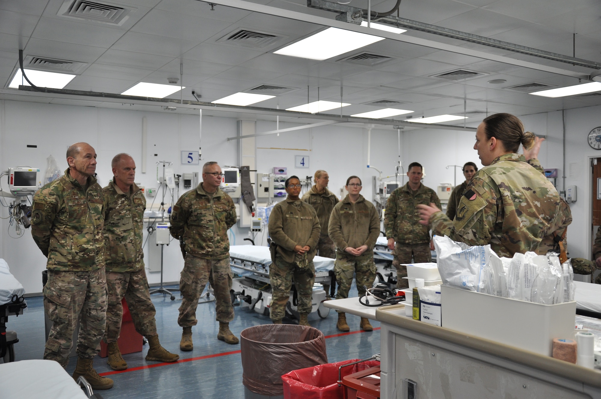 Airmen from the 455th Expeditionary Medical Group brief Gen. Mike Holmes, commander of Air Combat Command, and Chief Master Sgt. Frank H. Batten III, ACC command chief master sergeant, about patient care at Bagram Airfield, Afghanistan, Feb. 13, 2019.
