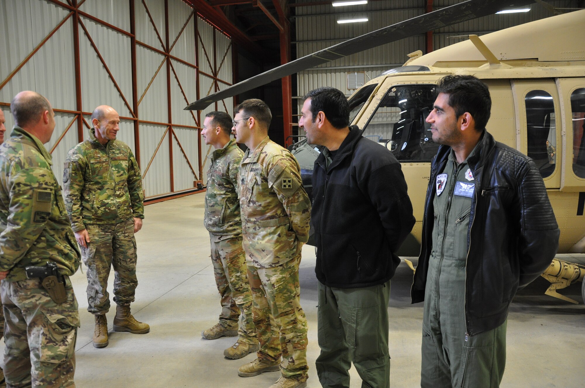 Gen. Mike Holmes, commander of Air Combat Command, meets Train Advise Assist Command-Air and Afghan Air Force personnel during a visit to Kandahar Airfield, Afghanistan, Feb. 13, 2019.