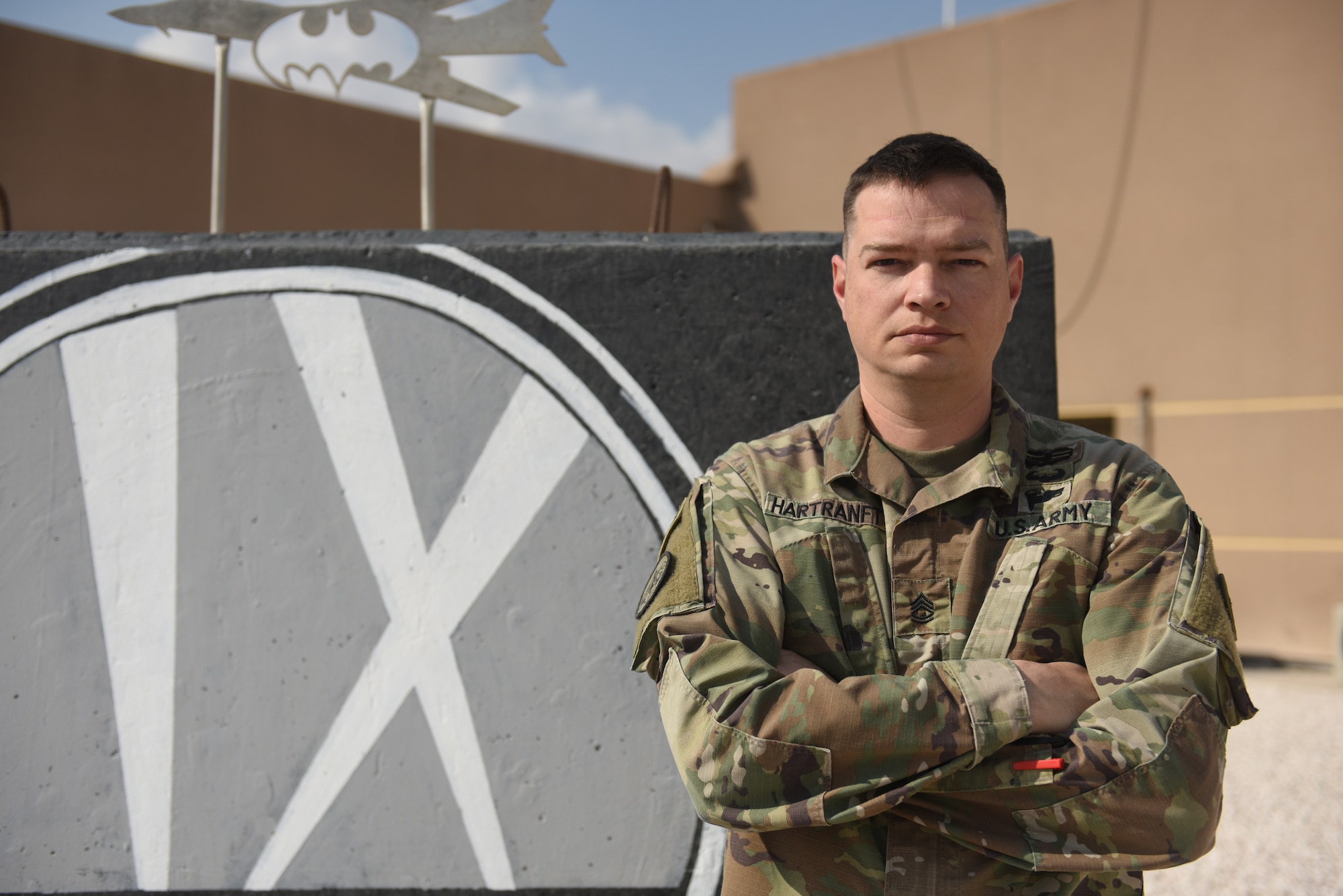 U.S. Army Sgt. 1st Class Timothy Hartranft, 9th Expeditionary Bomb Squadron ground liaison officer, stands in front of the 9th EBS T-Wall at Al Udeid Air Base, Qatar, Feb. 6, 2019. The GLO translates the ground units’ intent into action in the air, also known as green to blue. All GLOs within the U.S. Central Command area of responsibility are supplied by the 4th Battlefield Coordination Detachment which is a unit under U.S. Army Central. (U.S. Air Force photo by Senior Airman Travis Beihl)