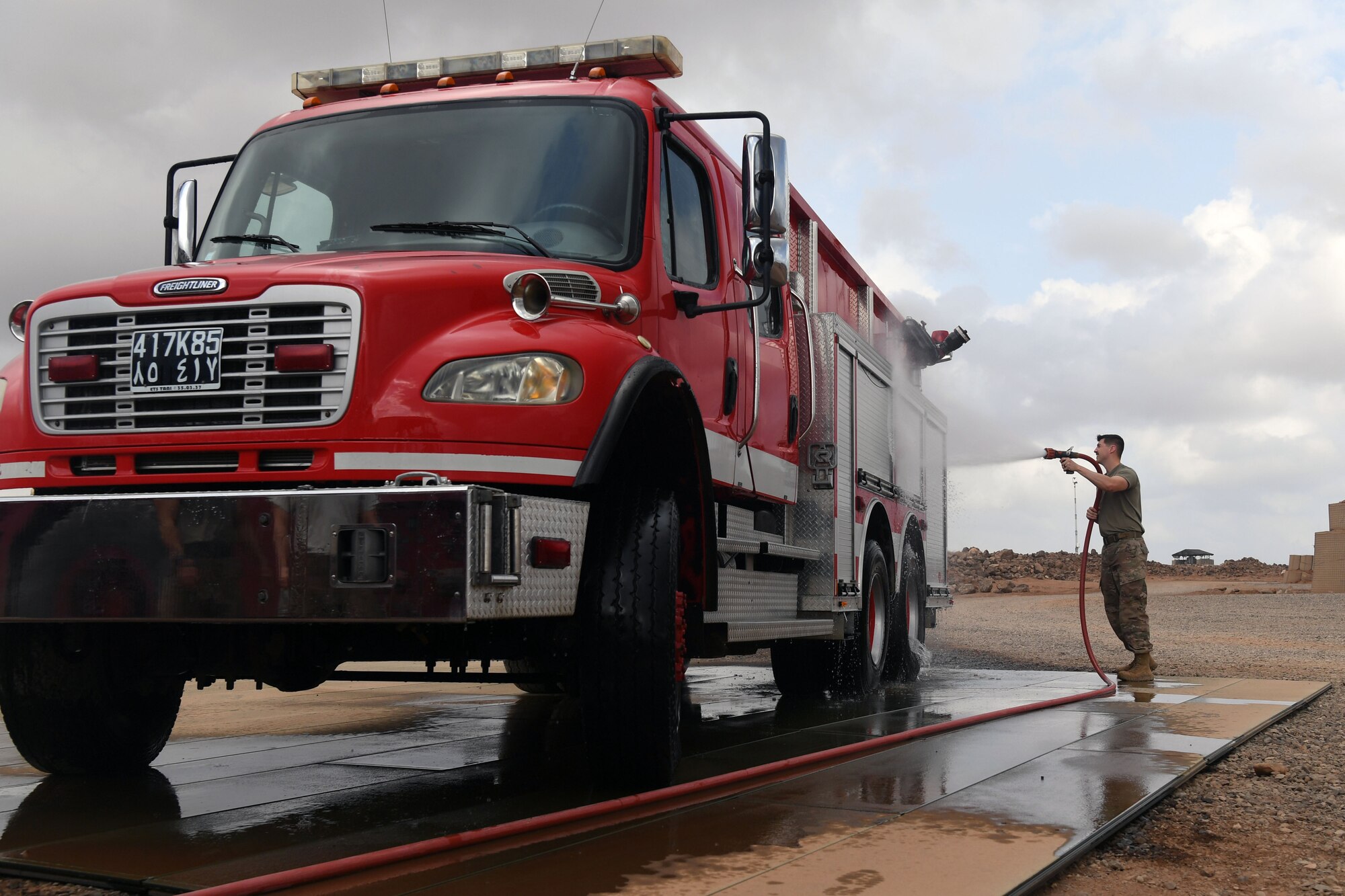 The 870th Air Expeditionary Squadron fire department and military community took part in a decades-old tradition and pushed a fire truck into its new home during a ceremony here Feb. 8.