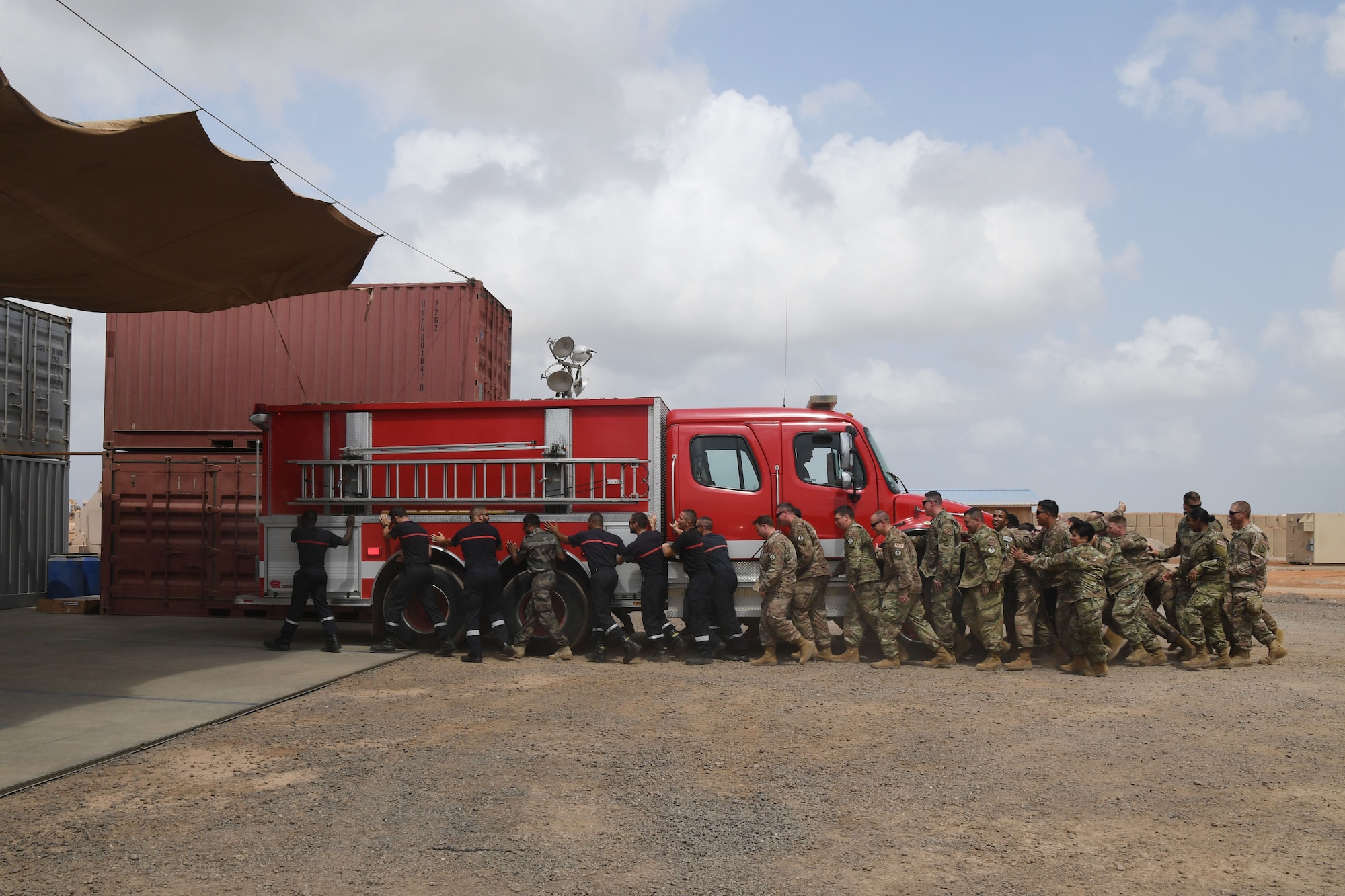 The 870th Air Expeditionary Squadron fire department and military community took part in a decades-old tradition and pushed a fire truck into its new home during a ceremony here Feb. 8.