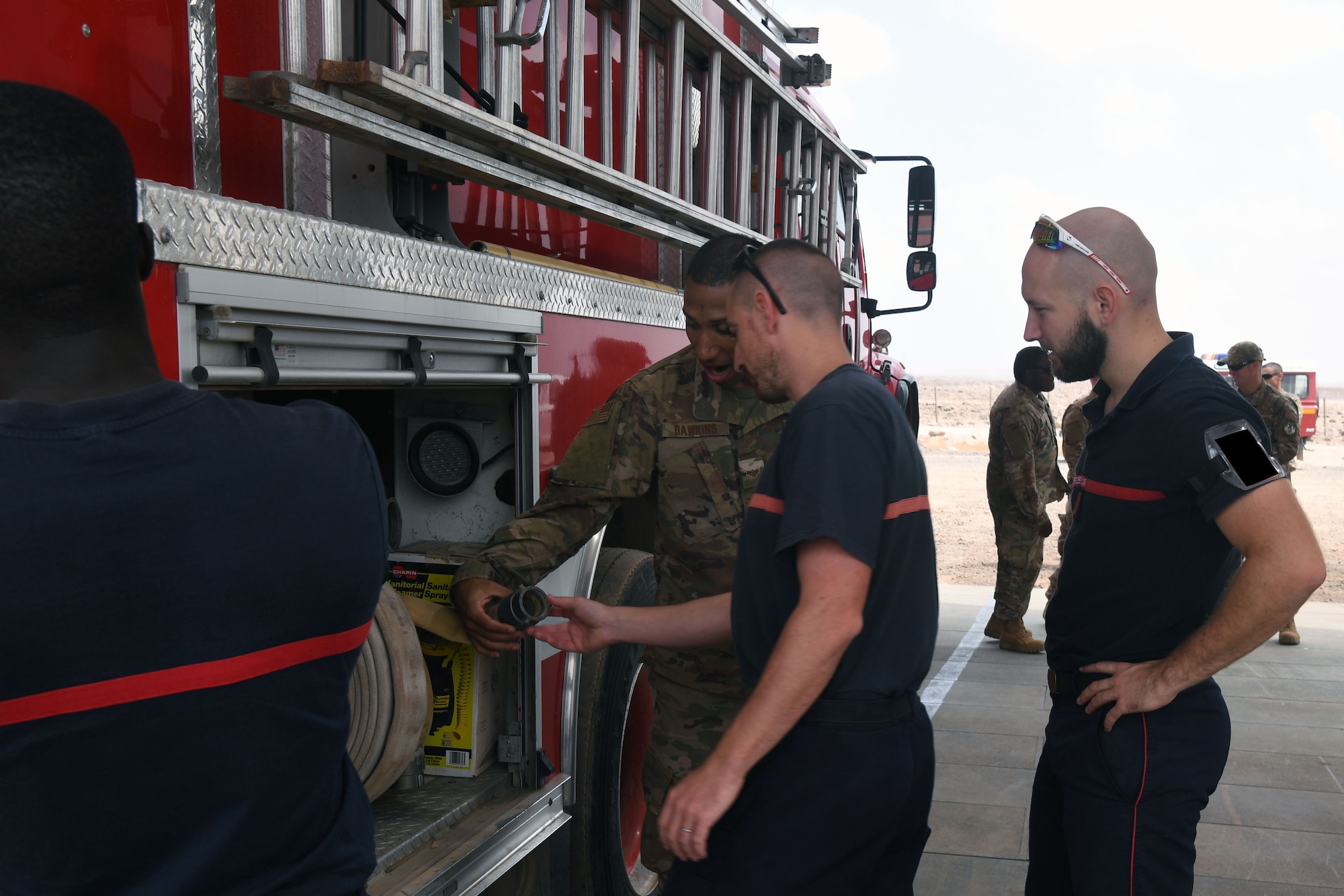 The 870th Air Expeditionary Squadron fire department and military community took part in a decades-old tradition and pushed a fire truck into its new home during a ceremony here Feb. 8.