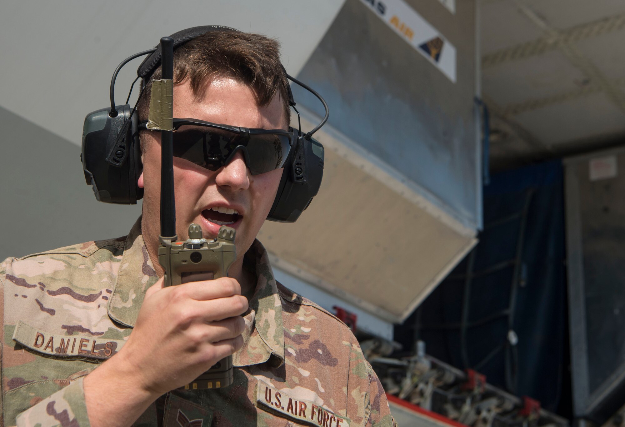 Senior Airman Samuel Daniels, 8th Expeditionary Air Mobility Squadron (EAMS) Air Terminal Operations Center ramp coordinator, helps coordinate the movement of baggage Feb. 20, 2019, at Al Udeid Air Base, Qatar. 8th EAMS Airmen ensure aircraft can rapidly and safely deliver vital equipment and passengers to locations across U.S. Central Command’s area of responsibility. The squadron consists of active-duty, Air Force Reserve, and Air National Guard Airmen, who bring a diverse total force perspective to their mission. (U.S. Air Force photo by Tech. Sgt. Christopher Hubenthal)