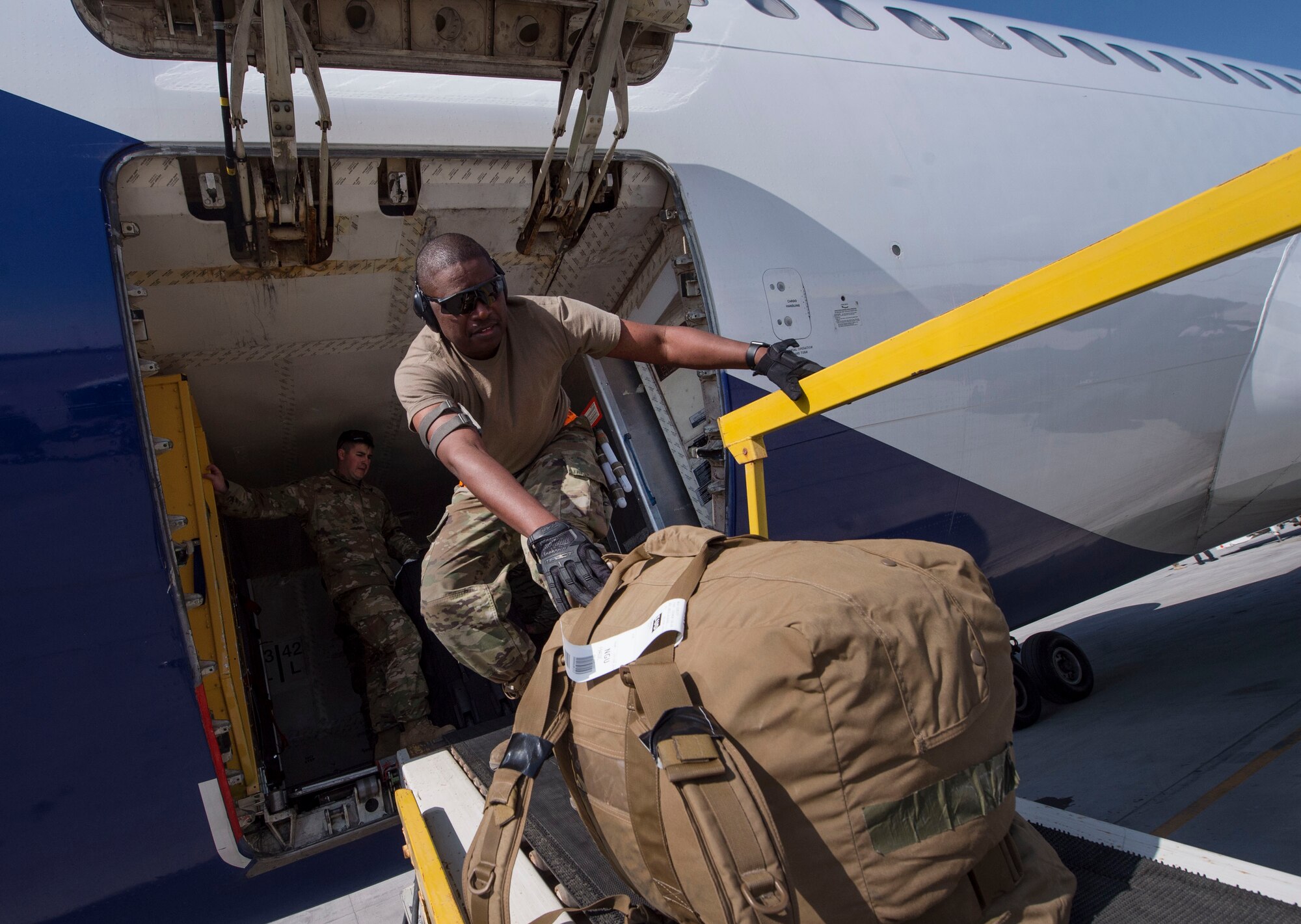 Staff Sgt. Brandon Littlejohn, 8th Expeditionary Air Mobility Squadron (EAMS) passenger services supervisor, moves baggage onto a conveyer belt Feb. 20, 2019, at Al Udeid Air Base, Qatar. 8th EAMS Airmen ensure aircraft can rapidly and safely deliver vital equipment and passengers to locations across U.S. Central Command’s area of responsibility. The squadron consists of active-duty, Air Force Reserve, and Air National Guard Airmen, who bring a diverse total force perspective to their mission. (U.S. Air Force photo by Tech. Sgt. Christopher Hubenthal)