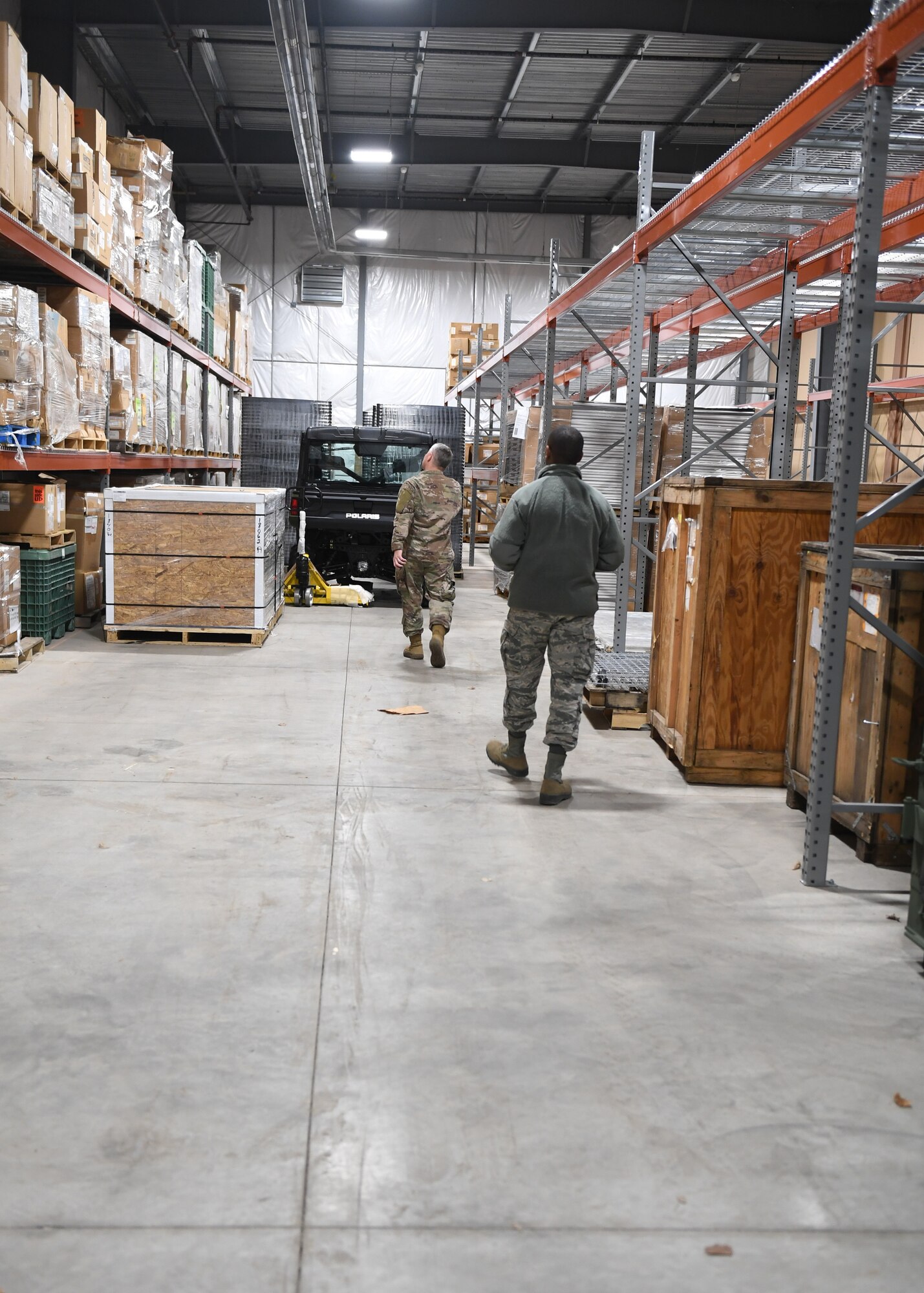 Tech. Sgt. Tobin Civils and Staff Sgt. Mamadou Bah, material management craftsmen with the 911th Logistics Readiness Squadron, walk along the warehouse floor at the Pittsburgh International Airport Air Reserve Station, Pennsylvania, Feb. 14, 2019. The warehouse became operational in early November and is expected to eventually hold gas masks and training gear once they are done moving from their previous location in building 320. (U.S. Air Force Photo by Senior Airman Grace Thomson)