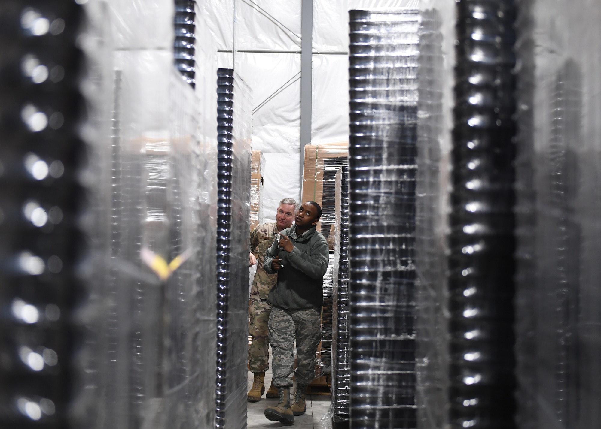 Tech. Sgt. Tobin Civils and Staff Sgt. Mamadou Bah, material management craftsmen with the 911th Logistics Readiness Squadron, walk through storage pallets at the Pittsburgh International Airport Air Reserve Station, Pennsylvania, Feb. 14, 2019. The newly constructed warehouse is still undergoing organization and will hold more materials as the 911th LRS moves in from their old home in building 320. (U.S. Air Force Photo by Senior Airman Grace Thomson)