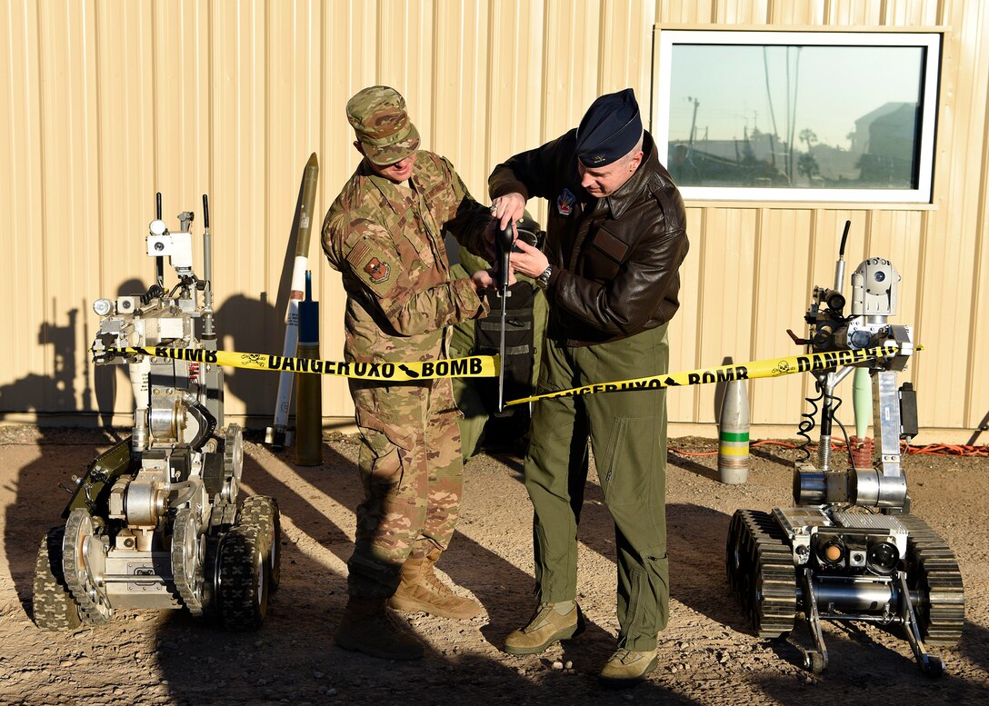 Senior Airman Henry Dodd, 56th Civil Engineer Squadron explosive ordnance disposal technician, and Col. Michael Richardson, 56th Fighter Wing vice commander, participate in a ribbon cutting ceremony, officially opening the new EOD facility at Luke Air Force Base, Ariz., Feb. 20, 2019.