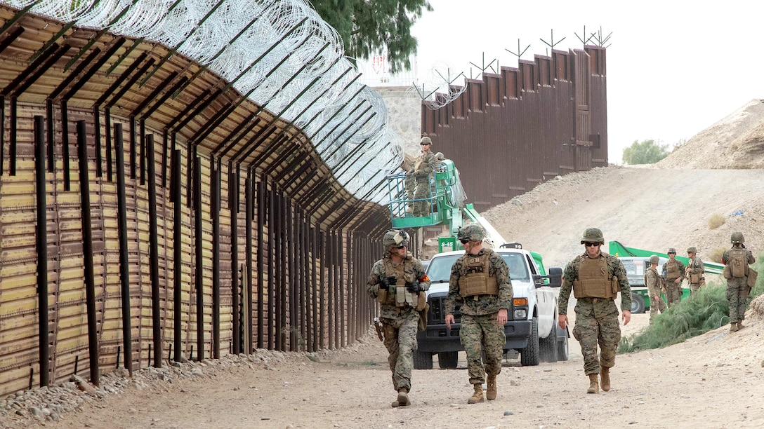 Marines with the 7th Engineer Support Battalion, Special Purpose Marine Air-Ground Task Force 7, walk along the California-Mexico border at the Andrade Point of Entry in Winterhaven, California. U.S. Northern Command provided support to the Department of Homeland Security and U.S. Customs and Border Protection to secure the southwest border of the United States.