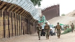 Marines with the 7th Engineer Support Battalion, Special Purpose Marine Air-Ground Task Force 7, walk along the California-Mexico border at the Andrade Point of Entry in Winterhaven, California. U.S. Northern Command provided support to the Department of Homeland Security and U.S. Customs and Border Protection to secure the southwest border of the United States.