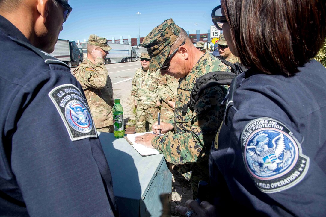 Marine Corps Brig. Gen. S.D. Slenka, commanding general of the 1st Marine Logistics Group, takes notes on the status of the border operation in Nogales, Arizona. DLA and Rapid Deployment Team Blue supported the effort by providing supplies to U.S. Northern Command.