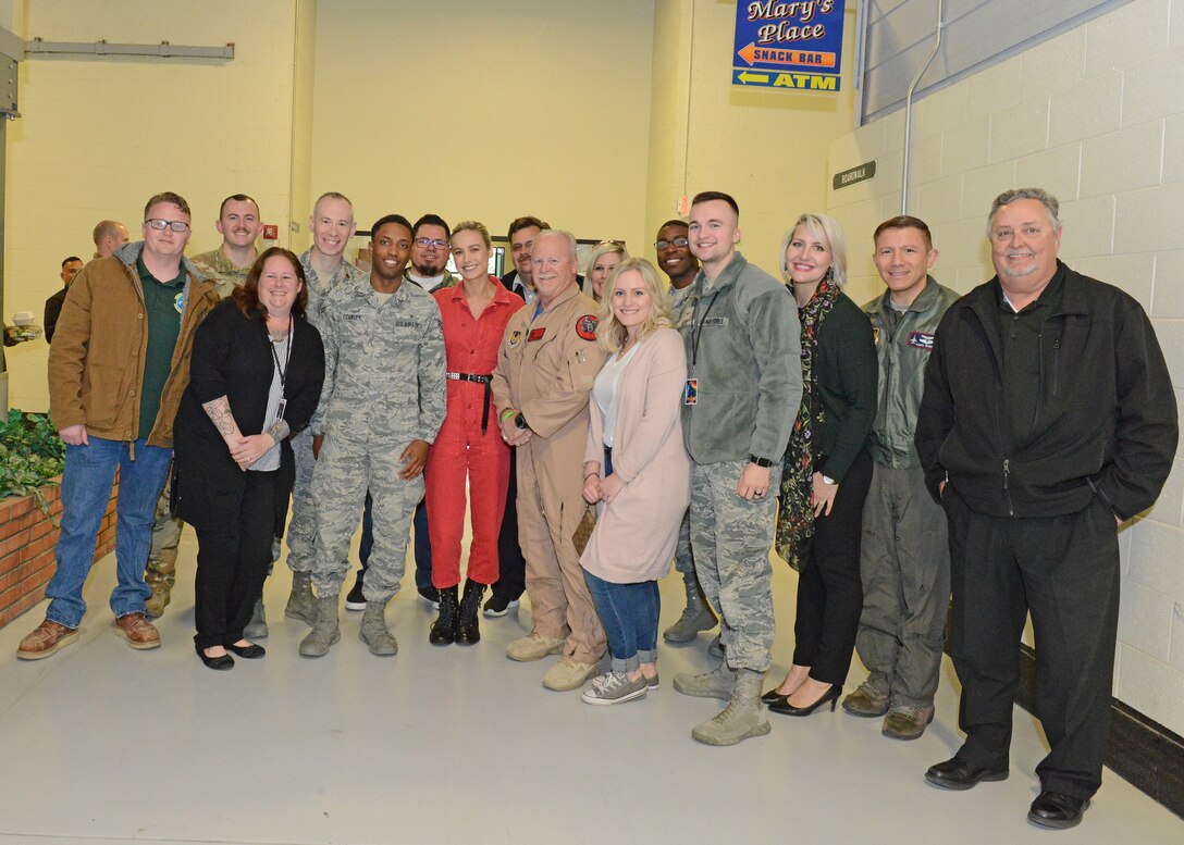 Actress Brie Larson (in red) poses for a photo with the 412th Test Wing Annual Award winners Feb. 20 in Bldg. 1600. (U.S. Air Force photo by Kenji Thuloweit)