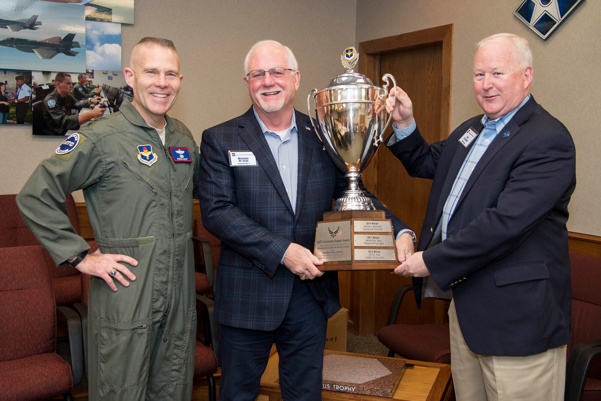 Lt. Gen. Steve Kwast (left), commander of Air Education and Training Command; Mr. Michael Boyd (center), Goodfellow Military Advisory Group member; and Dr. Joe Leverett, Altus Trophy committee chairman, hold up the Altus Trophy during the AETC Civic Leader's meeting Feb. 21, 2019, at Joint Base San Antonio-Randolph, Texas. The city of San Angelo (Texas) was awarded the trophy for 2019 for its outstanding community support to Goodfellow Air Force Base, Texas.