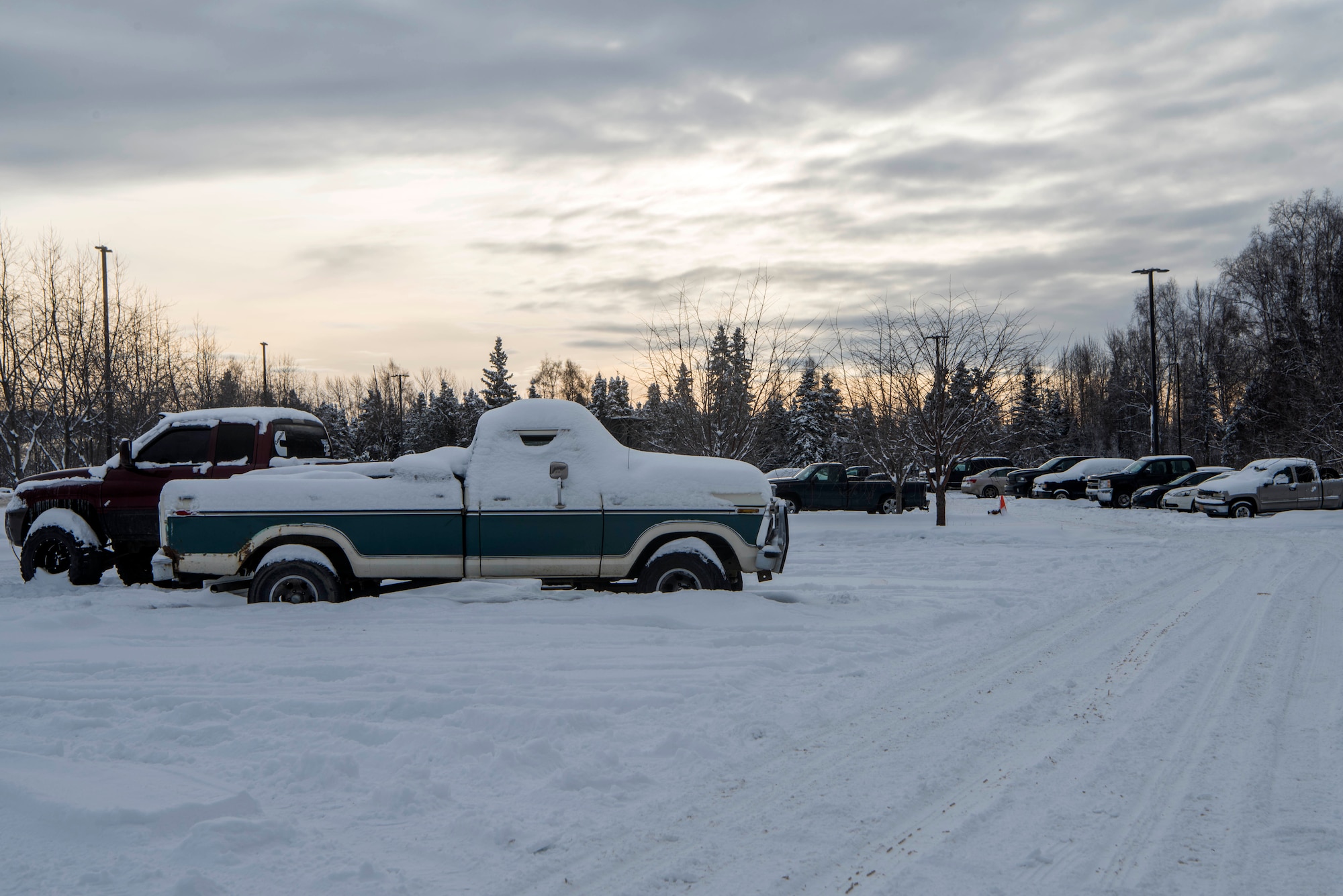 Abandoned vehicles sit in the dormitory parking lots at Joint Base Elmendorf-Richardson, Alaska, Feb. 7, 2019. Some of these vehicles have created hazardous conditions by obstructing the path for snow-plowing vehicles.