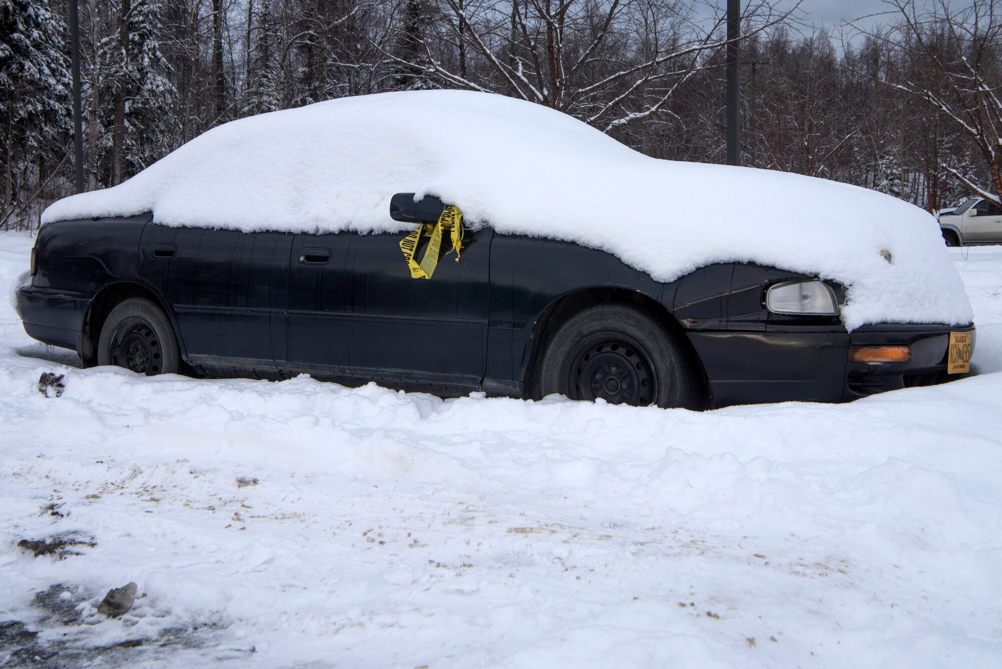Abandoned vehicles sit in the dormitory parking lots at Joint Base Elmendorf-Richardson, Alaska, Feb. 7, 2019. Some of these vehicles have created hazardous conditions by obstructing the path for snow-plowing vehicles.