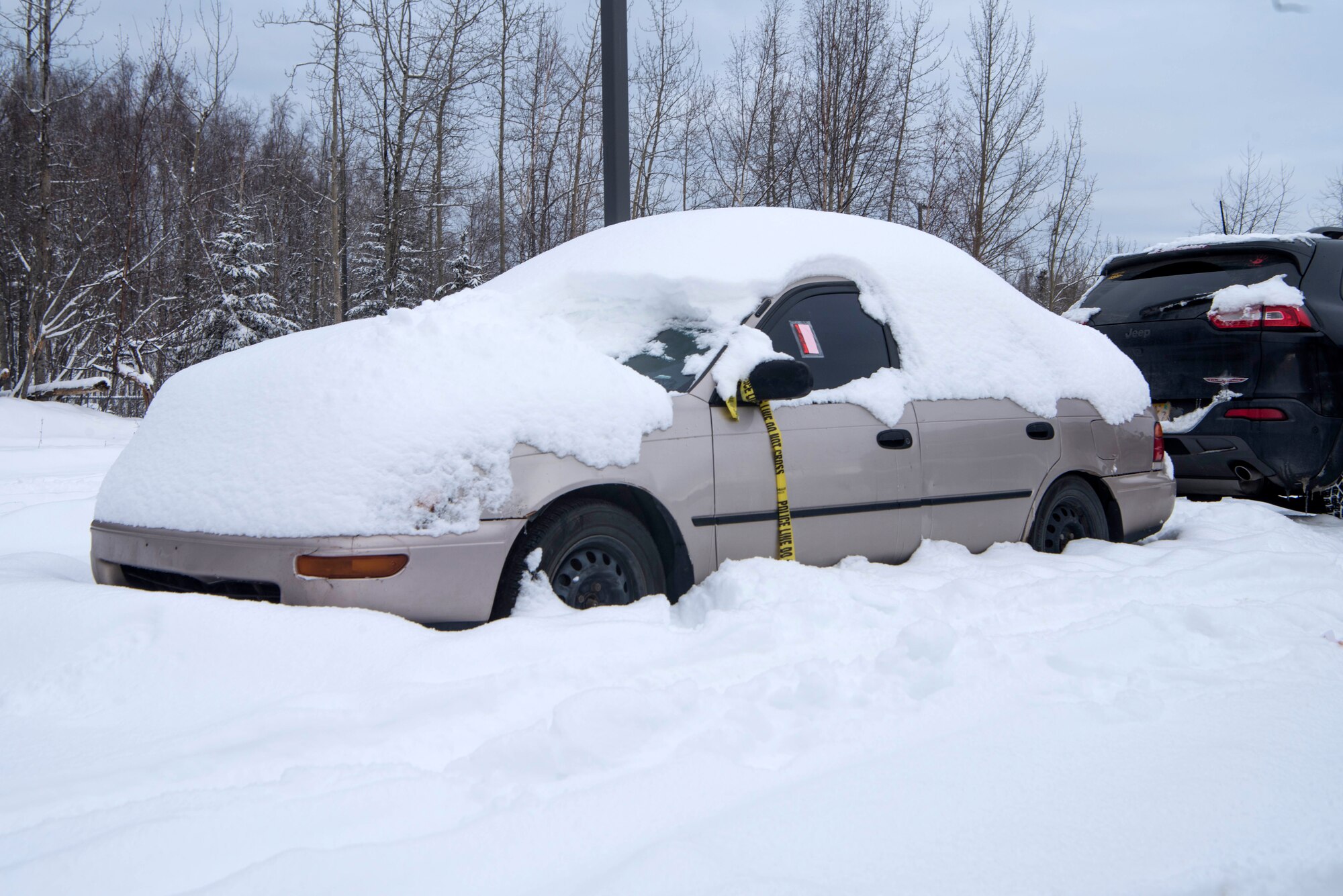 Abandoned vehicles sit in the dormitory parking lots at Joint Base Elmendorf-Richardson, Alaska, Feb. 7, 2019. Some of these vehicles have created hazardous conditions by obstructing the path for snow-plowing vehicles.