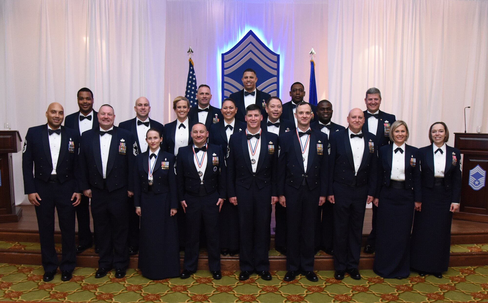 Recently inducted and current Keesler chief master sergeants pose for a photo during the Chief Induction Ceremony inside the Bay Breeze Event Center at Keesler Air Force Base, Mississippi, Feb. 15, 2019. Five Keesler Airmen earned their chief master sergeant stripe during the 2019 promotion release. Air Force officials selected 479 senior master sergeants for promotion to chief master sergeant out of 2,241 eligible for a selection rate of 21.37 percent. Chief master sergeants make up one percent of the Air Force enlisted force. (U.S. Air Force photo by Kemberly Groue)