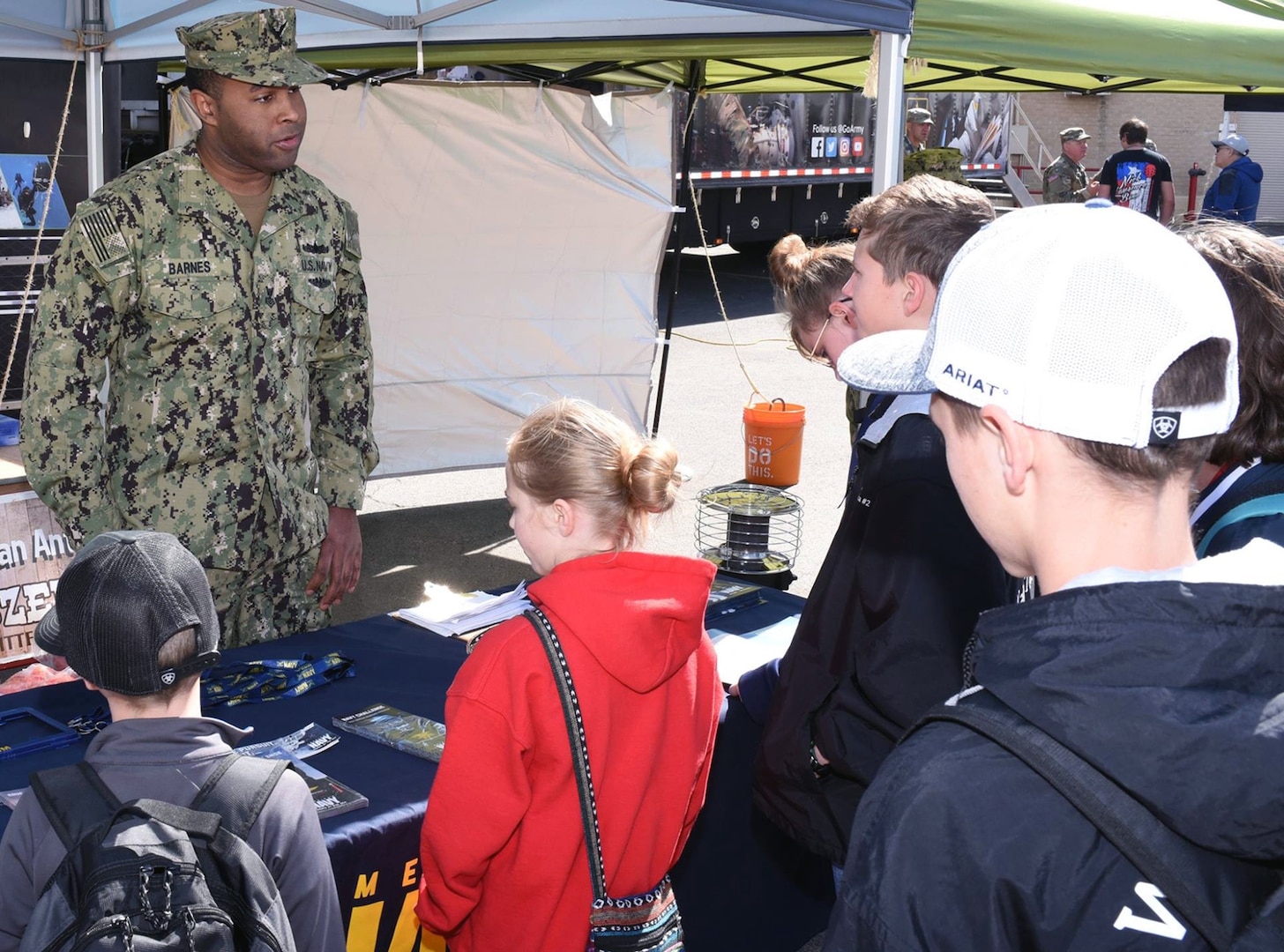 Petty Officer 1st Class Vincent Barnes of Navy Recruiting District San Antonio, speaks with attendees at the San Antonio Stock Show and Rodeo.