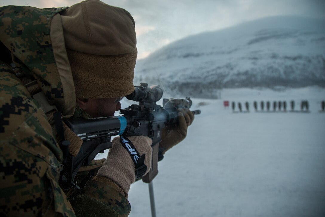 Marine aiming a rifle at targets