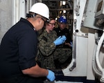 NAVAL STATION ROTA, Spain (January 25, 2019) Damage Controlman 2nd Class Jesus Figueroa, left, and Damage Controlman 1st Class Sarah Aumiller, center, from Mid-Atlantic Regional Maintenance Center (MARMC) provide preventative maintenance training to Gas Turbine Systems Technician (mechanical) 2nd Class Jeremy Lovelace aboard Arleigh Burke-class destroyer USS Carney (DDG 64). MARMC sent a training team to Rota but normally provides services for more than 70 ships in the Mid-Atlantic region to ensure the ships and their crews are able to fulfill their missions with minimal repair and maintenance downtime.