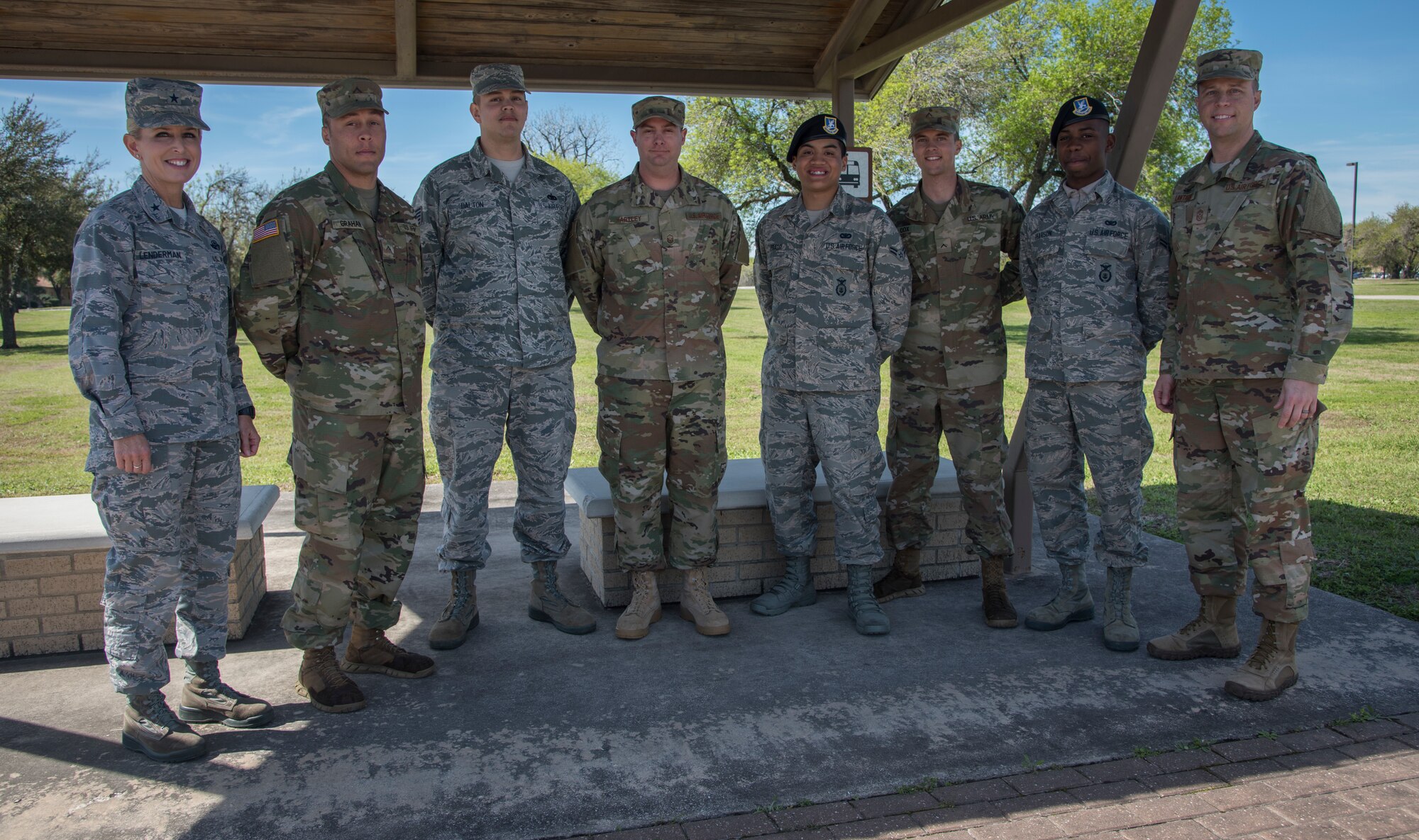 Brig. Gen. Laura Lenderman, 502d Air Base Wing and Joint Base San Antonio commander, and Chief Master Sgt. Christopher Lantange, JBSA command chief, pose with creators of JBSA’s new shuttle application “Ride Systems,” Tech. Sgt. Cody Dalton, 502d Logistics Readiness Squadron NCO in charge of contracting officer representatives; and Master Sgt. Justin Hartley, JBSA ground transportation support supervisor; and technical training military members at a JBSA-Lackland bus stop Feb. 20, 2019. The app includes Global Positioning System tracking capabilities with mapping and coordination with the ground transportation offices to track exactly where each bus is, their route and how long the wait time is.