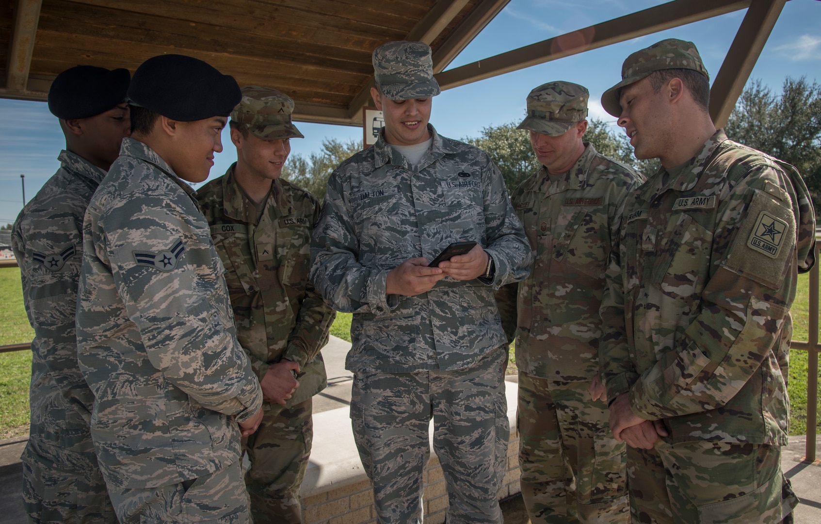 Tech. Sgt. Cody Dalton, 502d Logistics Readiness Squadron NCO in charge of contracting officer representatives, and Master Sgt. Justin Hartley, Joint Base San Antonio ground transportation support supervisor, showcase the “Ride Systems” application for JBSA shuttles to technical school students waiting for the bus at JBSA-Lackland Feb. 20, 2019.  The app includes Global Positioning System tracking capabilities with mapping and coordination with the ground transportation offices to track exactly where each bus is, their route and how long the wait time is.