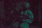 A U.S. Soldier sits behind an M-240H Machine Gun inside a CH-47 Chinook during aerial gunnery training in Belize, Feb. 11, 2019.