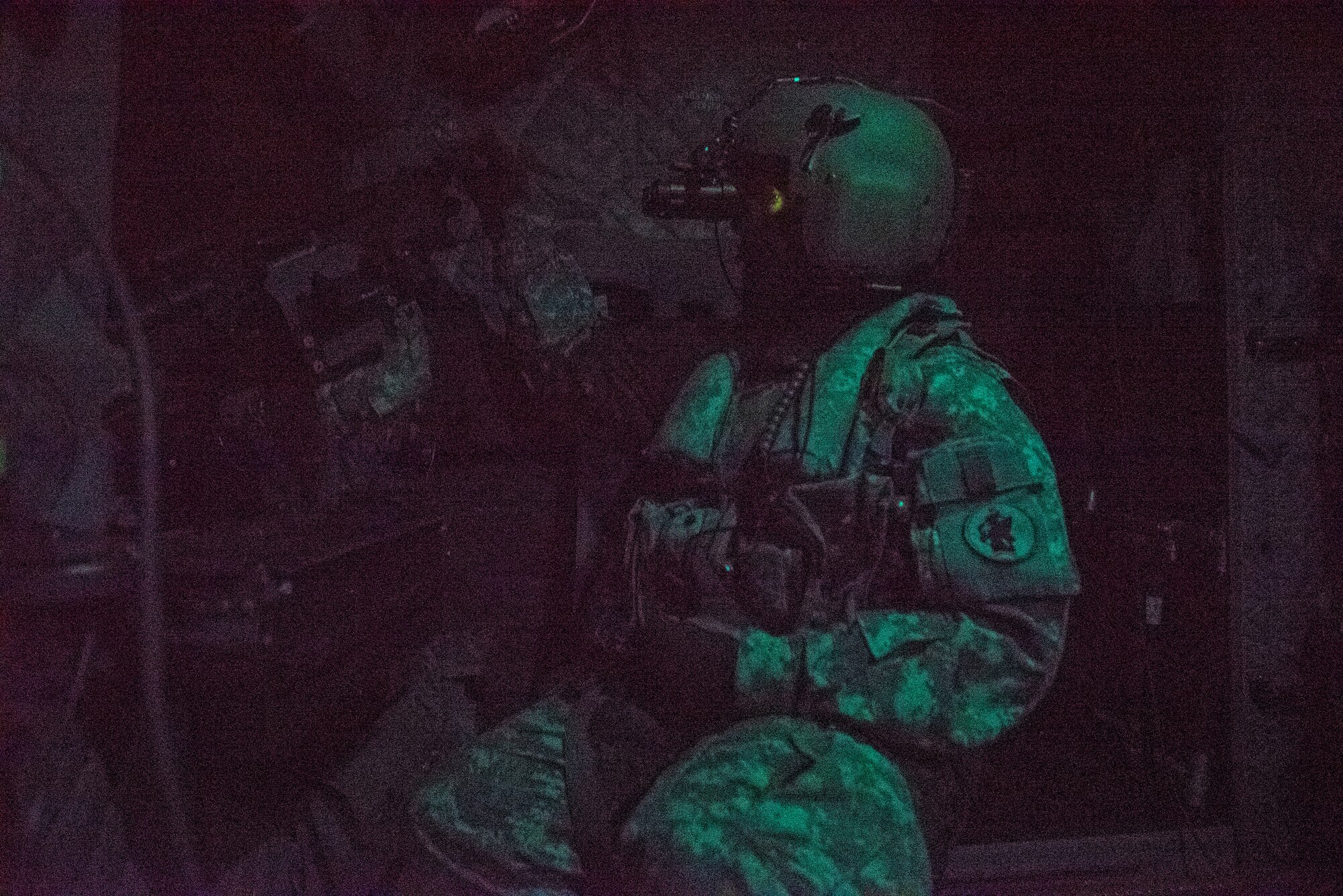 A U.S. Soldier sits behind an M-240H Machine Gun inside a CH-47 Chinook during aerial gunnery training in Belize, Feb. 11, 2019.