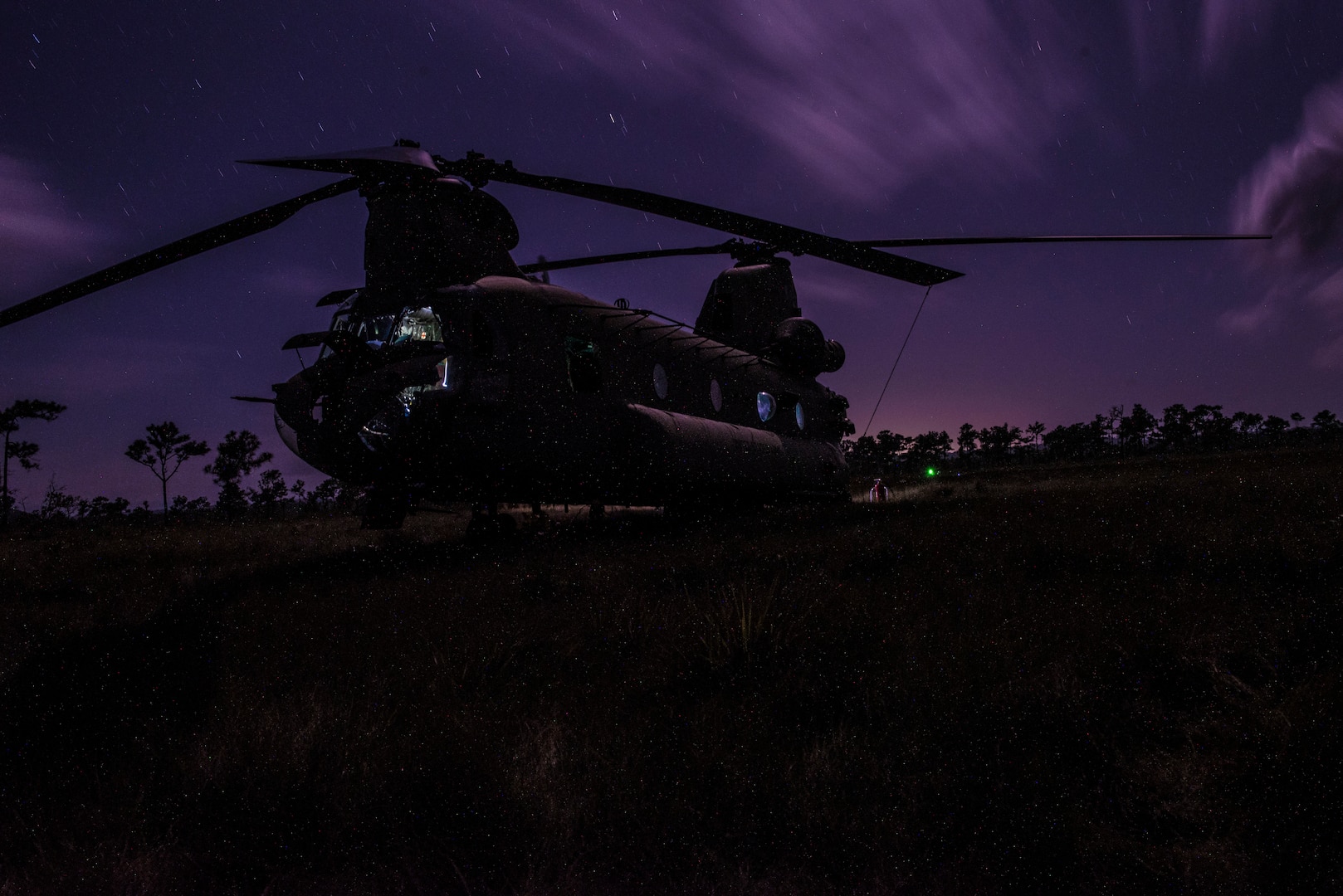 A U.S. Army CH-47 Chinook sits in a field during aerial gunnery training in Belize, Feb. 11, 2019.