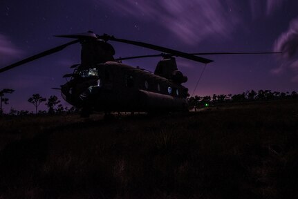 A U.S. Army CH-47 Chinook sits in a field during aerial gunnery training in Belize, Feb. 11, 2019.