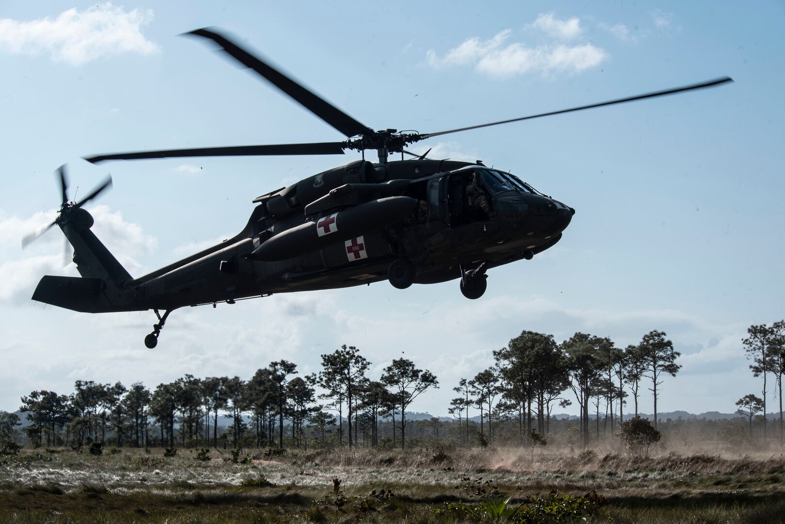 An HH-60 MEDEVAC returns from aerial gunnery training over a range in Belize, Feb. 12, 2019.